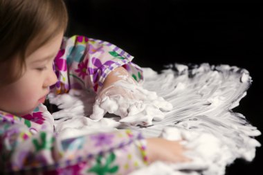 Creative Toddler Playing with White Foam clipart