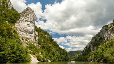 The statue of Decebal carved in the mountain - closeup clipart