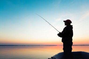 Man fishing from the boat clipart