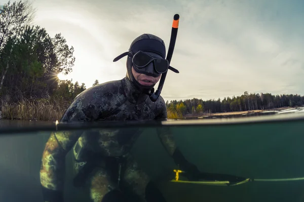 Fisherman in wet suit and with a speargun — Stock Photo, Image