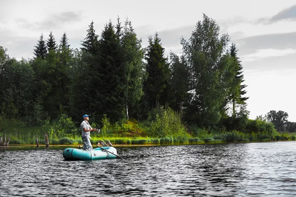 Mature man fishing on the lake — Stock Photo, Image
