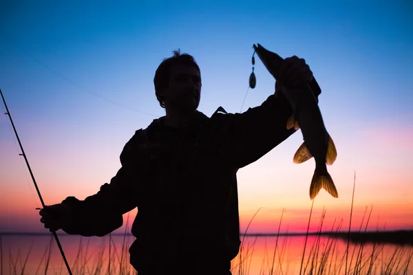Мужчина рыбачит на озере — стоковое фото
