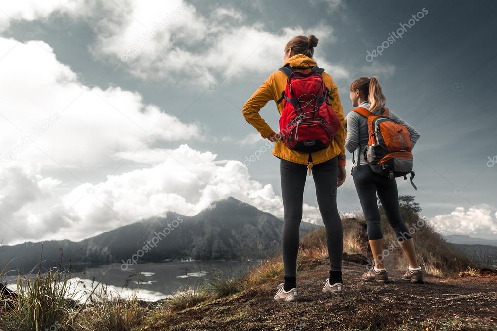 Two ladies hikers standing on top
