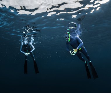Two free divers preparing for the dive clipart