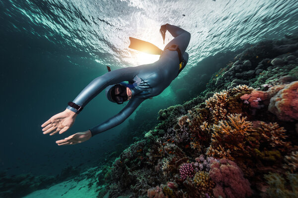 Free diver swimming underwater