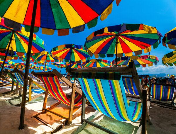 Beach with colourful sun loungers