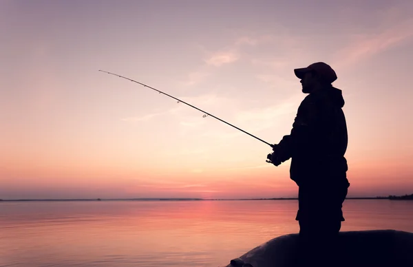 Homem com uma vara de pesca — Fotografia de Stock