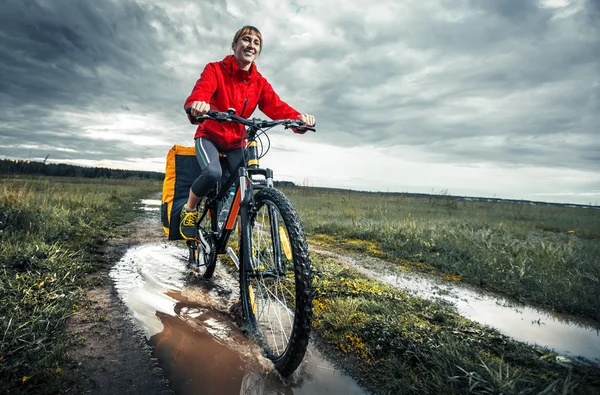 Junge Wanderin mit beladenem Fahrrad — Stockfoto