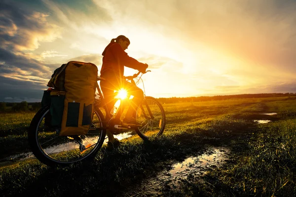 Young girl with bicycle on a rural road — Stock Photo, Image