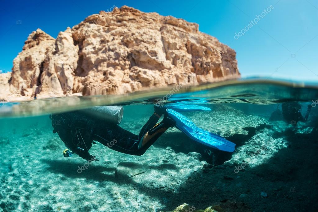 Diver underwater and rocky land — Stock Photo © mihtiander 125578236