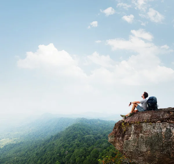 Hiker relaxing on the rock Stock Image