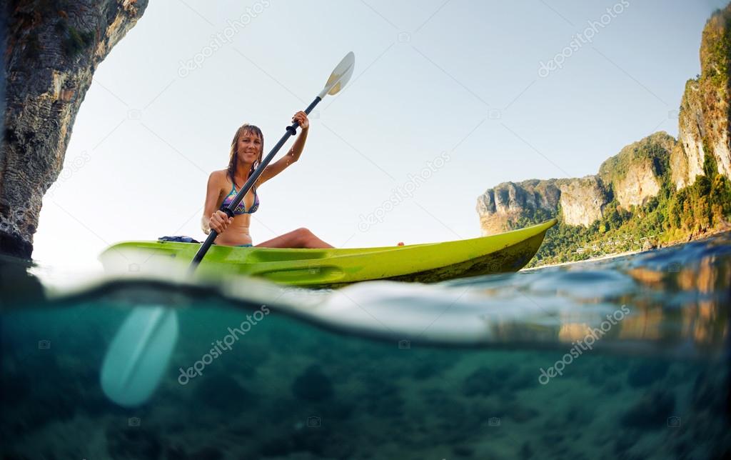 Young lady paddling the kayak