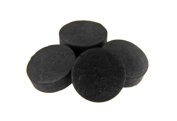 Pile de pilules de charbon noir — Photo