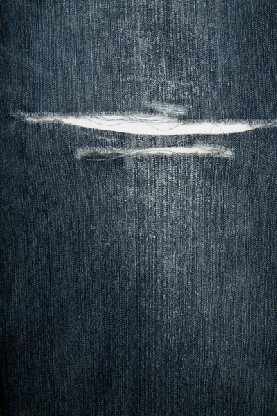 Tecido de jeans rasgado — Fotografia de Stock