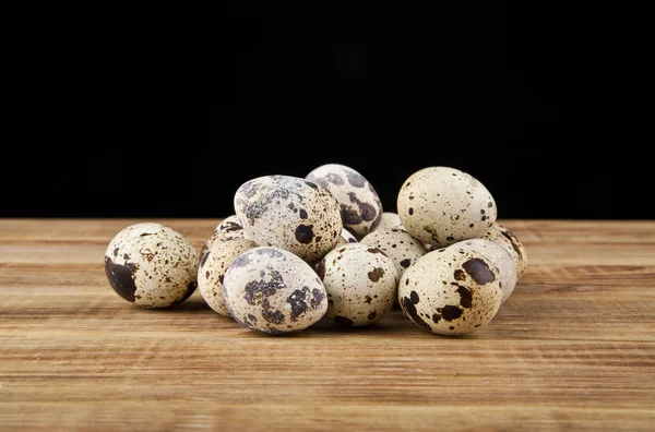 Quail eggs are isolated on a black background — Stock Photo, Image