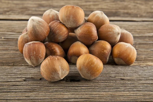 Hazel-nuts on wood — Stock Photo, Image