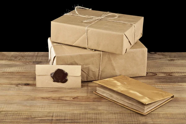 Post parcels and book on table — Stock Photo, Image