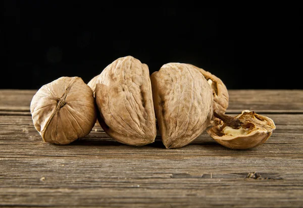 Nuts on table on black — Stock Photo, Image