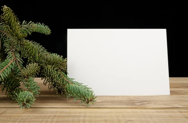 Branch of fir-tree and empty card — Stock Photo, Image