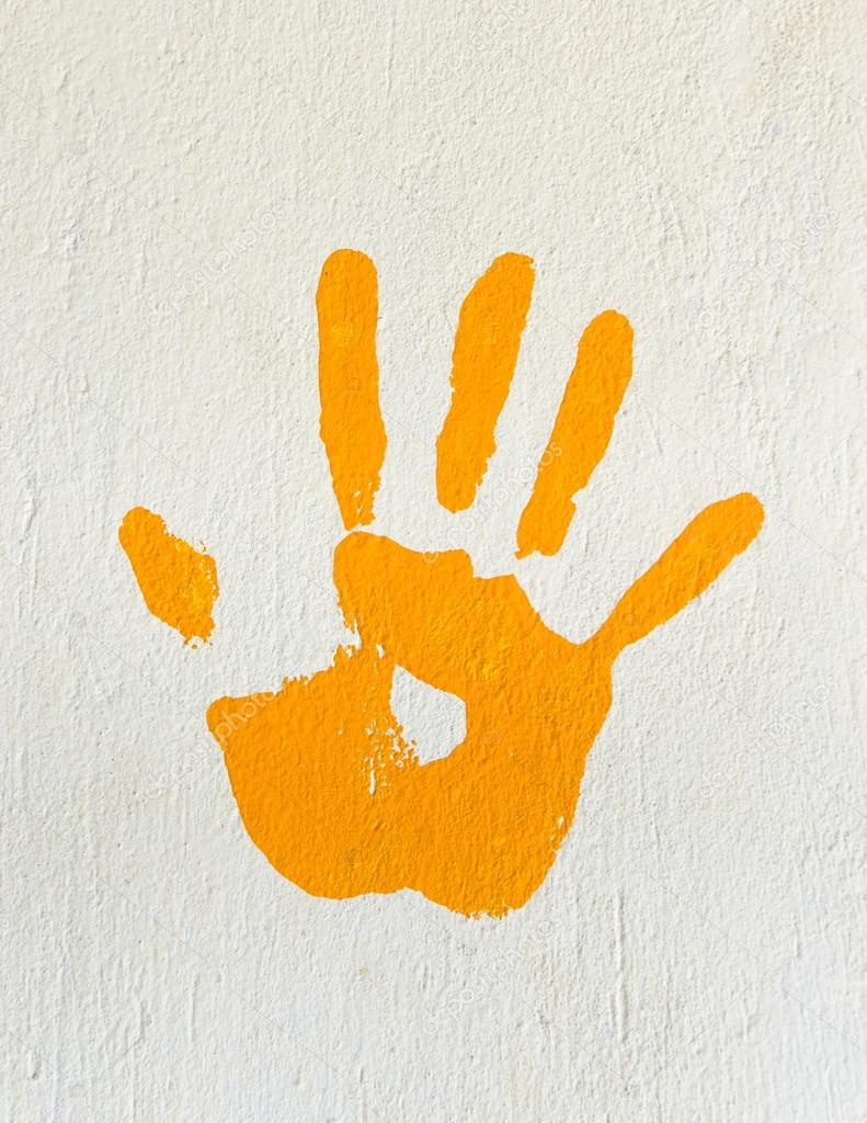 Orange handprint on a wall