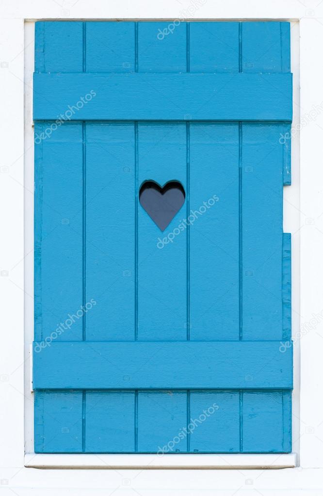 Wooden shutter with a carved heart