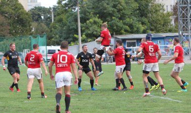 ODESSA, UKRAINE -20.10.17 - Ukrayna ragbi şampiyonası finali CREDO (Odessa) - kırmızı, OLYMPIK (Kharkiv) siyah rugby oyuncularının top için yoğun mücadelesi. Yeşil sahada dinamik bir oyun. Acımasız ragbi