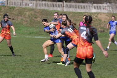 ODESSA, UKRAINE -17 Nisan 2021: 7 bayanlar ragbi takımı arasında Ukrayna Kupası. Odessa - mavi, Kiev Havacılık - turuncu. Kadın ragbi maçının gerginlik anı. Bayanlar ragbi takımı için dramatik meydan okuma oyunu