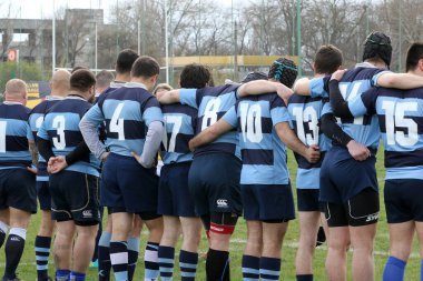 ODESSA, UKRAINE - 17 Nisan 2021: Rugby Kupası 7. Odessa Polytechnic Derby - mavi, CREDO - kırmızı. Erkeklerin ragbi maçının gergin anı. Dramatik ve zorlu erkek ragbi müsabakası. Erkekler ragbi sahasında savaşır