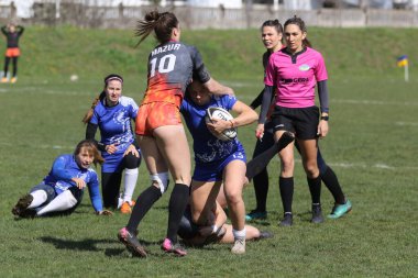 ODESSA, UKRAINE -17 Nisan 2021: 7 bayanlar ragbi takımı arasında Ukrayna Kupası. Odessa - mavi, Kiev Havacılık - turuncu. Kadın ragbi maçının gerginlik anı. Bayanlar ragbi takımı için dramatik meydan okuma oyunu