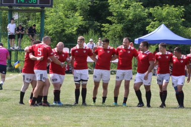 Odessa, Ukrayna - 23 Haziran 2021: Odessa Milli Takımı CREDO (kırmızı) - OLYMP-Kharkiv (sarı) in rugby 7s. Top için erkek rugby oyuncularının sert agresif dövüşü. Stadyumun yeşil çimlerinde dinamik bir oyun