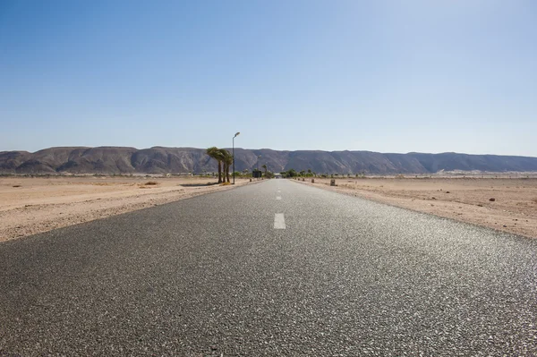 Estrada através de um deserto remoto — Fotografia de Stock