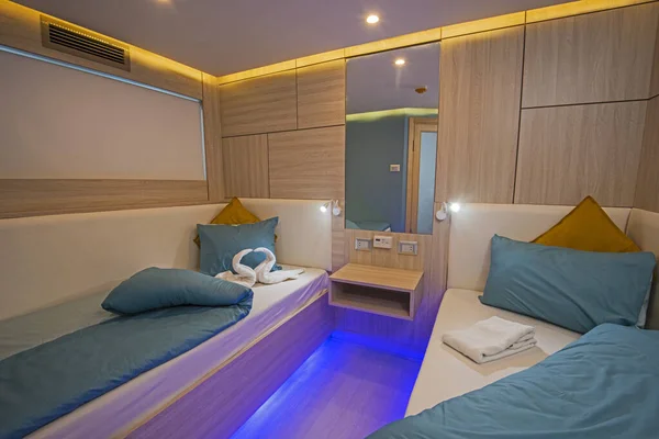 Interior of cabin bedroom on luxury sailing yacht with twin beds