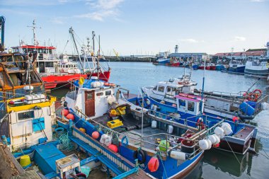 Rıhtımda demirlemiş balıkçı tekneleri ile sahil kenti limanı manzarası