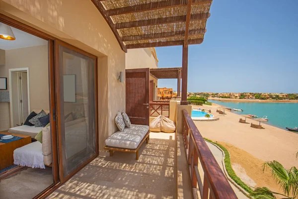 Terrace furniture at a luxury apartment in tropical resort with lounge and beach view to sea