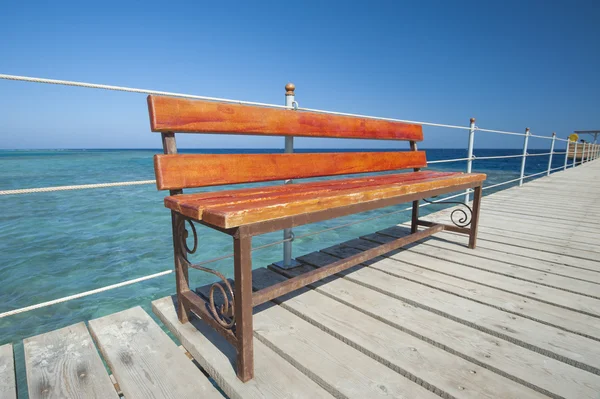 Wooden bench on tropical jetty — Stock Photo, Image