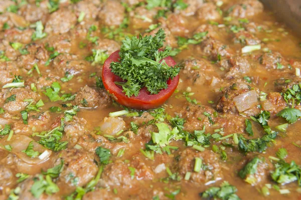 Beef meatballs in tomato sauce at an oriental buffet — Stock Photo, Image