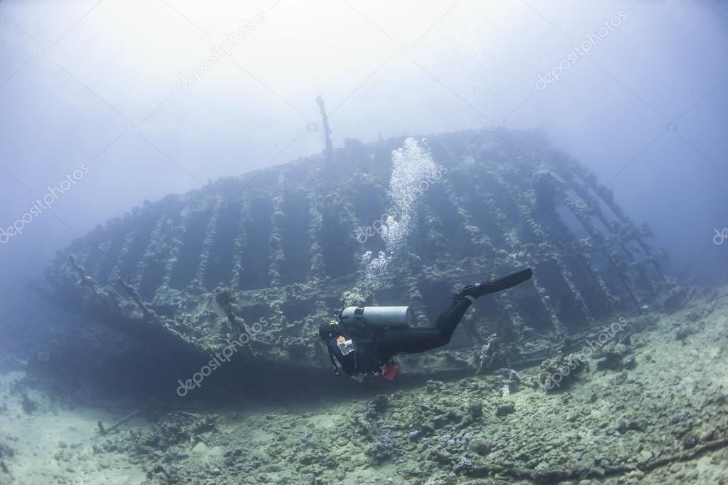 Diver exploring a large shipwreck