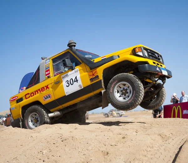 Off-road trucks competing in a desert rally