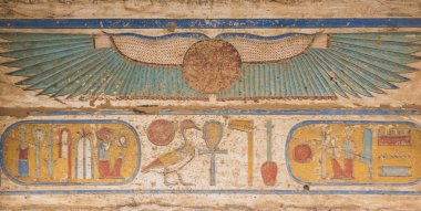 Egyptian hieroglyphics on a temple wall clipart