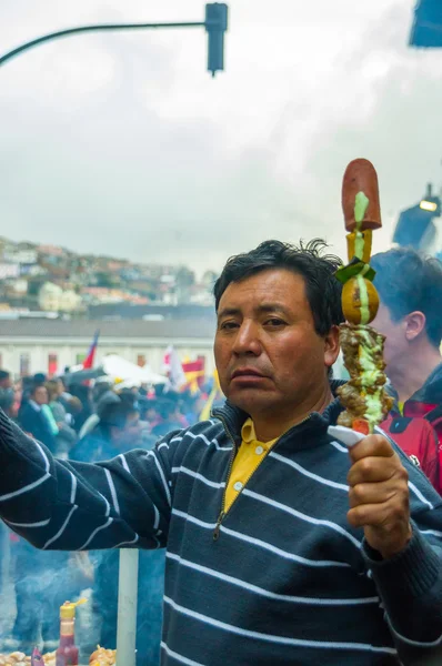 Quito, Ecuador - August 27, 2015: Man selling barbecue skewers in city streets during anti government mass demonstrations — Stock Photo, Image