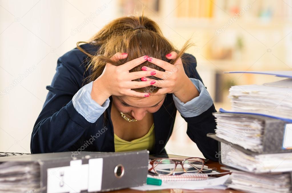 Business Woman Sitting By Desk Paper Files Spread Out Elbows On