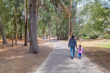 QUITO, ECUADOR - MARZO 23, 2015: Unidentified people walking trough a park finding some shadow, perfect day to walk