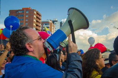 Quito, Ekvator - 7 Nisan 2016: Bilinmeyen muhalefet protestocu kişi, polis ve anti Shyris Avenue hükümet protesto sırasında gazeteciler tarafından çevrili megafon ile