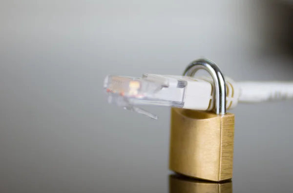 Small padlock with ethernet cable going through it, internet security concept — Stock Photo, Image