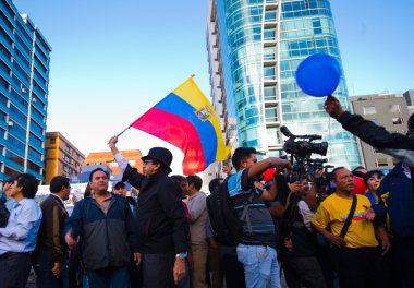 Quito, Ekvator - 7 Nisan 2016: Grup insanlar Holding protesto işaretler, polis ve anti Shyris Avenue hükümet protesto sırasında gazeteciler ile balonlar