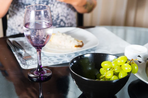 Stijlvolle diner tafel setting met zwarte kom van groene druiven aan de voorkant focus — Stockfoto