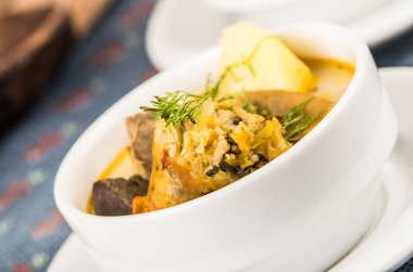 Patates çorbası et ve siste, klas porsiyon servis oturma tablo, mavi masa örtüsü, rahat Restoran arka plan üzerinde beyaz kase