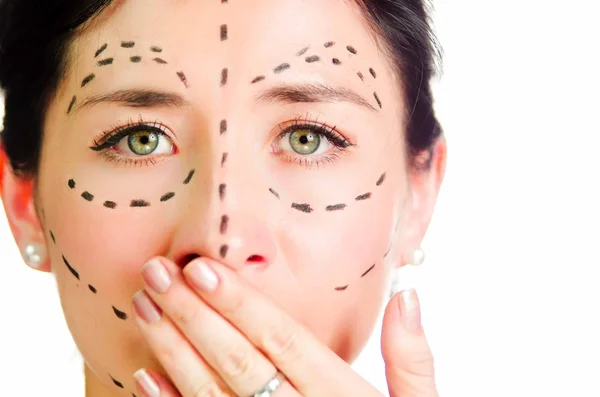 Closeup headshot caucasian woman with dotted lines drawn around face looking into camera, skeptical facial expression, preparing cosmetic surgery — Stock Photo, Image