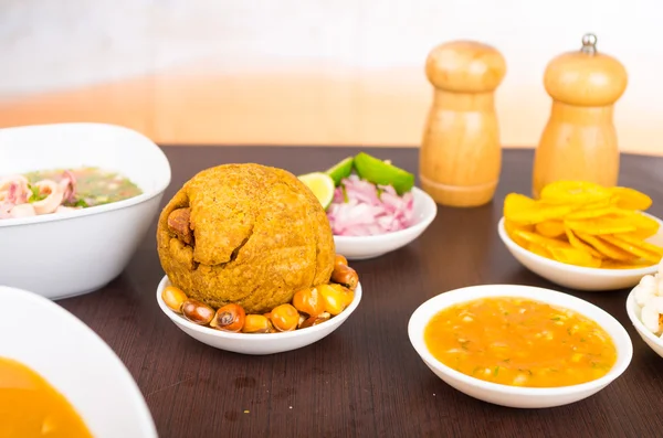 Traditional ecuadorian food, selective focus on bolon and fried corn with spicy sauce — Stock Photo, Image