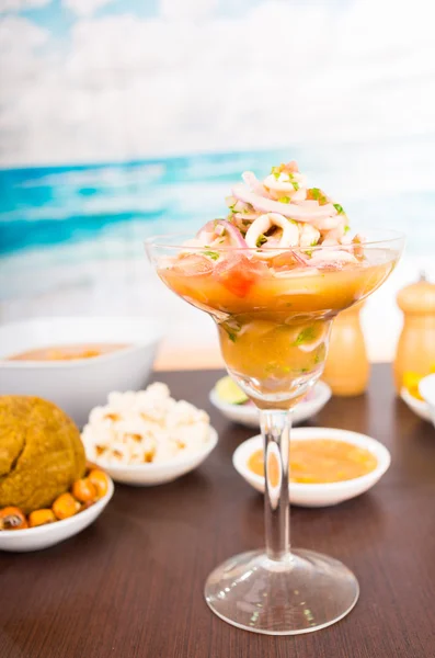 Squid delicious ceviche on wooden table, behind traditional ecuadorian food — Stock Photo, Image